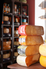 Assortment of tasty cheese on counter in store