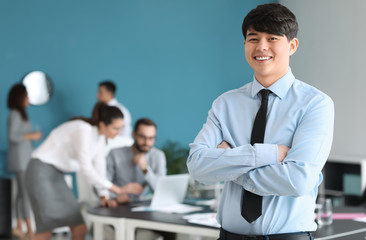 Young Asian businessman at meeting in office