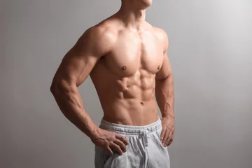 Fotobehang Muscular bodybuilder on light background © Pixel-Shot