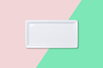 Empty white plate on bicolored background
