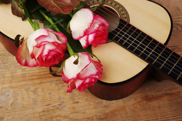 Acoustic guitar and a bouquet of roses