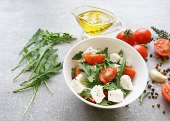 Italian cuisine. Vegetarian food. Salad with mozzarella, arugula and cherry tomatoes.