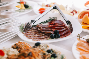 Dish with sliced meat products on the festive table