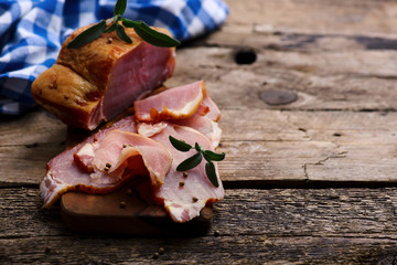 The cut  a smoked pork on a wooden table