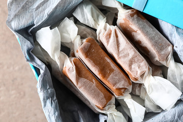 Box with tasty caramel candies on table