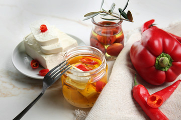 Composition with tasty feta cheese in oil on table