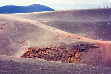 People walking on Mount Etna, active volcano on the east coast of Sicily, Italy.
