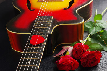 Acoustic guitar and a bouquet of roses