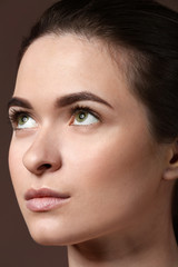 Fototapeta premium Young woman with beautiful eyebrows on color background, closeup