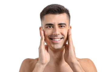Man giving himself face massage on white background