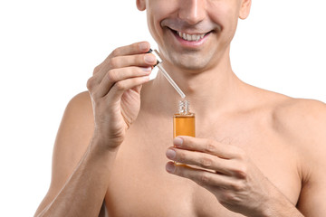 Fototapeta premium Handsome man with face serum on white background