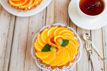 Jelly baked cake with jelly and fresh fruits, grapefruit, grapes and orange