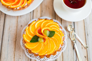 Jelly baked cake with jelly and fresh fruits, grapefruit, grapes and orange