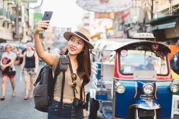 Asian woman tourist backpacker travel in Khao San road, Bangkok, Thailand