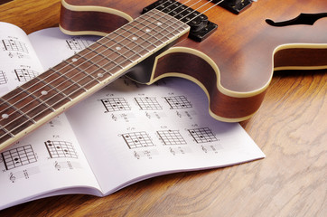 Fototapeta na wymiar Electric guitar and an open book with guitar chords.