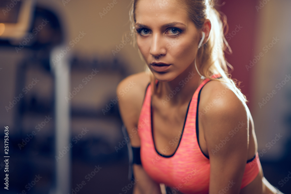 Wall mural Close up of woman posing in a gym. Healthy lifestyle concept.