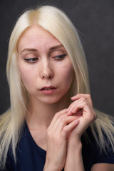 beauty female blond in black casual clothes on gray background