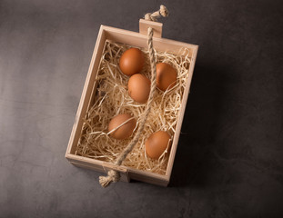 Easter basket with eggs, shot on a dark background