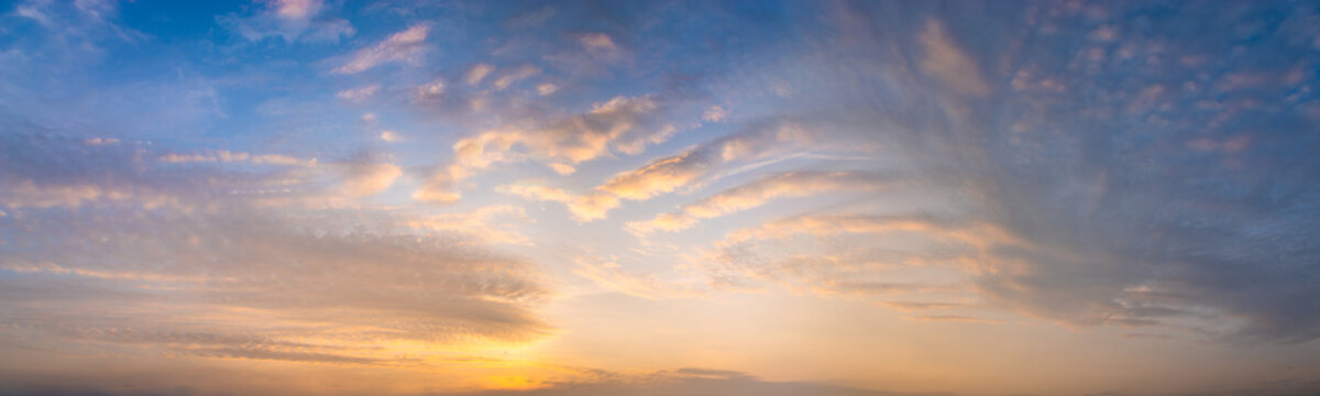 beautiful clouds in warm pastel colors during sunrise - high resolution panorama