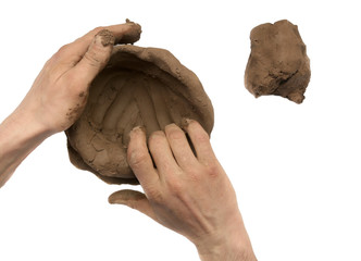 Modeling natural clay piece in hands  isolated on white background. Wet clay material for sculpting...