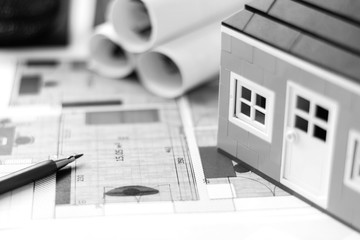 Drawings, layout of the house, documents, calculator on the desktop in the office. Engineering, construction, business.