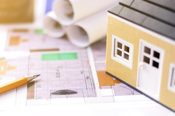 Drawings, layout of the house, documents, calculator on the desktop in the office. Engineering, construction, business.