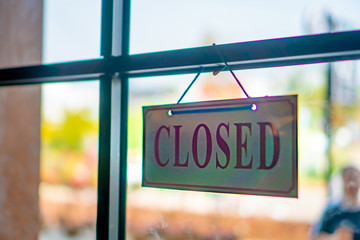 Sorry we are closed sign hang on door of business shop.