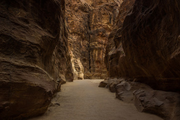 canyon empty narrow path way between steep rocks scenic landscape place without people in shadows in evening twilight time