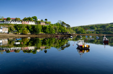 Fototapeta na wymiar Reflection of boats on the water. Town Portree - Scotland