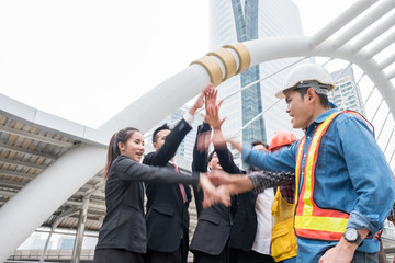 Group of business person with engineering partnership with hand raised up celebration of success