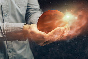 Man holding New Home Mars. Mixed media.