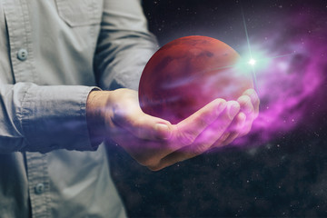 Man holding New Home Mars. Mixed media.