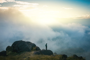 Instagram filter young man Asia tourist at mountain is watching over the misty and foggy morning sunrise, travel Trekking