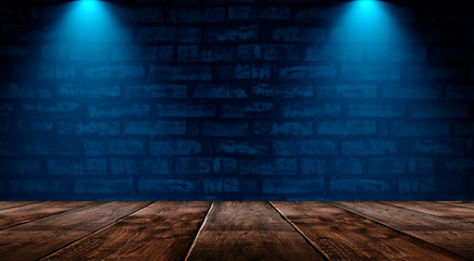 Dark empty room with brick walls and neon lights, smoke, rays. Brick wall, concrete and wooden table.
