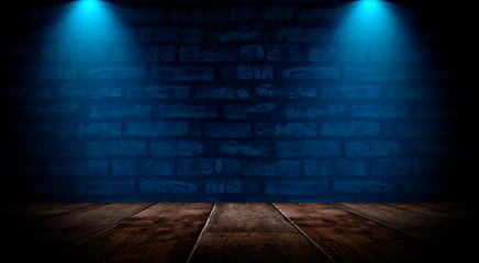 Dark empty room with brick walls and neon lights, smoke, rays. Brick wall, concrete and wooden table.