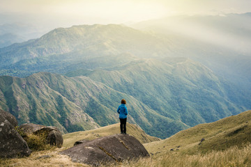  Instagram filter young Asia tourist at mountain is watching over the misty and foggy morning sunrise, travel Trekking