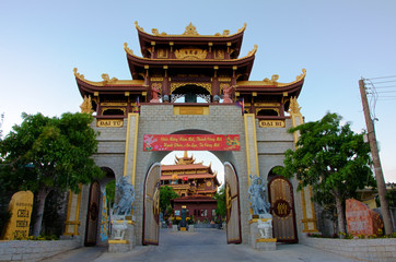 The gates of the Buddhist temple Thien Quang Tu with statues.  Sunset. Province Binh Thuan, Phan Thiet, Vietnam.