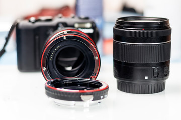 macro ring for the lens. increase focus. There is a camera and a lens. shallow depth of cut.