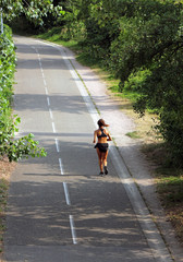 sportswoman running on a cycle lane