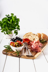 Italian antipasti with mediterranean olives, parma ham