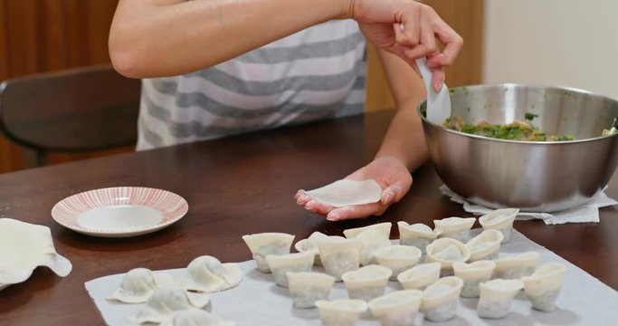 Woman make with chinese meat dumpling at home