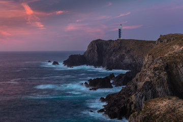 Lighthouse of Punta Frouxeira (also known as Lighthouse of Meir&aacute;s) at sunset in the cliffs of Valdovi&ntilde;o