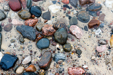 Texture of stones on the beach on a cloudy day.