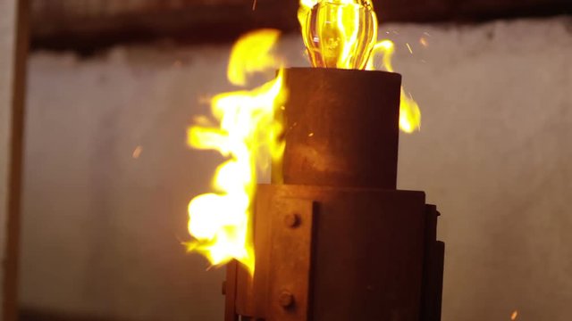 Glassworks manufacturing process . Production of glass bottles . Bottle manufacturing industrial factory . Molten glass . Glass factory . Process of creating glass products . Slow motion . Close up . 
