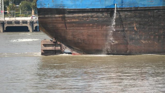 Empty cargo ship sailing in Huangpu river, close up of stern of the large ship, 4k movie, slow motion.