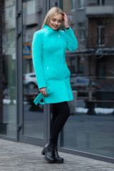 young stylish beautiful woman walking in street, wearing coat , fashion outfit, autumn trend.