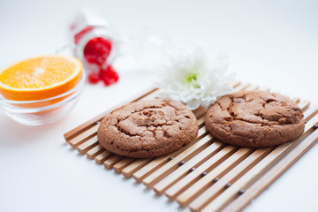 Fresh backed cookies and fruits. Delicious and healthy breakfast on the white background. Space for a text. Top view.
