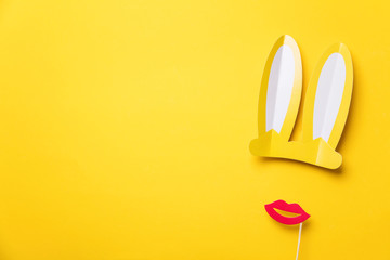 Easter bunny ears and red lips on yellow. Minimal lay flat design