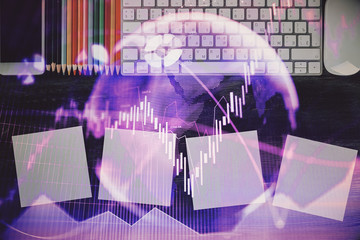 Double exposure of stock market chart and office desktop on background. financial strategy concept.