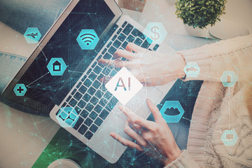 AI (Artificial Intelligence) concept. deep learning. Double exposure hands typing laptop.